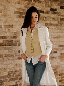 Female model standing with hands in pocket looking down wearing Nili Lotan shirt, vest, & trench with Frame jean