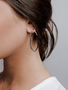 Female model wearing earring by Emanuela Duca