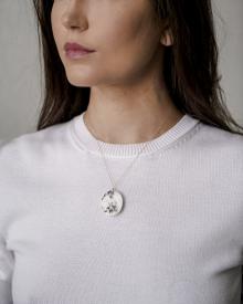 Close up of female neck white sweater and focused jewelry on Emanuela Duca