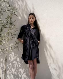 Female model in bamboo shadows wearing black Lareida Dress