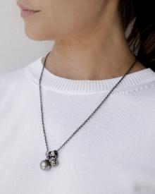 Close up of female neck wearing white sweater and forced jewelry on Rene Escobar 