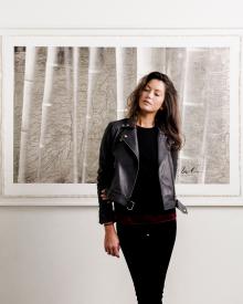 Model standing in front of painting wearing black IRO Jacket & Jeans and black 6397 Sweater 