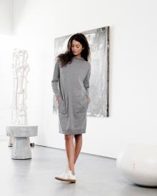 Model  walking through art gallery wearing gray Bruno Manetti Sweater Dress and white Maison Margeila Replica Sneakers