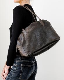 Woman model holding brown leather B. May Bag