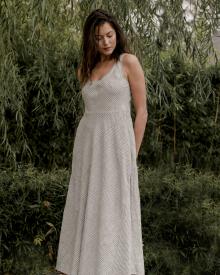 Model wearing Rosso 35 Dress in front of Willow Tree.