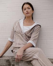 female model sitting on bench wearing peserico