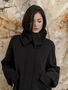Model wearing Annette Gortz Jacket in front of Painting.