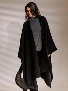 Model wearing drapey cape by The Row
