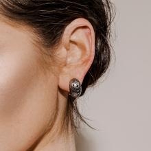 Model wearing silver hoop earring