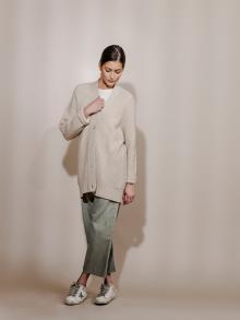 Model wearing cream cardigan and olive pants