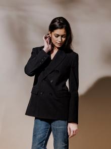 Model wearing black blazer and jeans