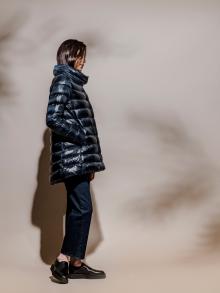 Model wearing puffy navy jacket