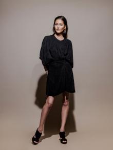 Model wearing short black dress